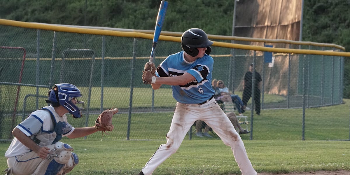Exciting moment captured at a youth baseball game with players sliding on the dust...