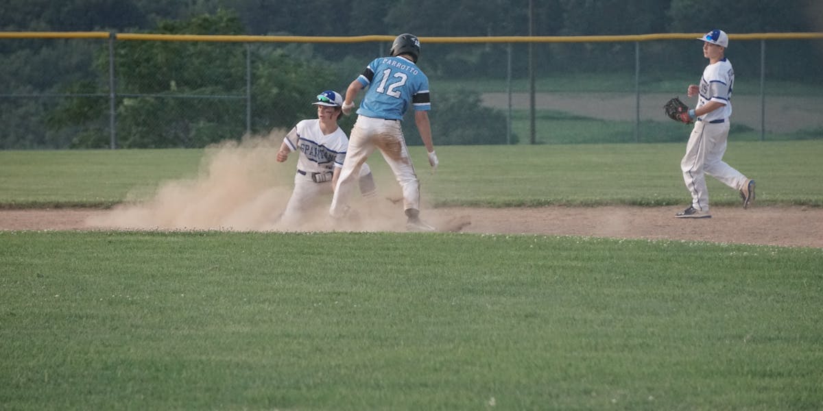 Focused close-up of old baseballs with visible stitching and texture against a dar...
