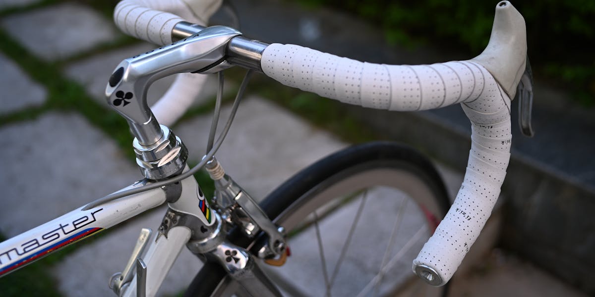 Detailed black and white shot of a gym bicycle saddle, highlighting fitness equipm...