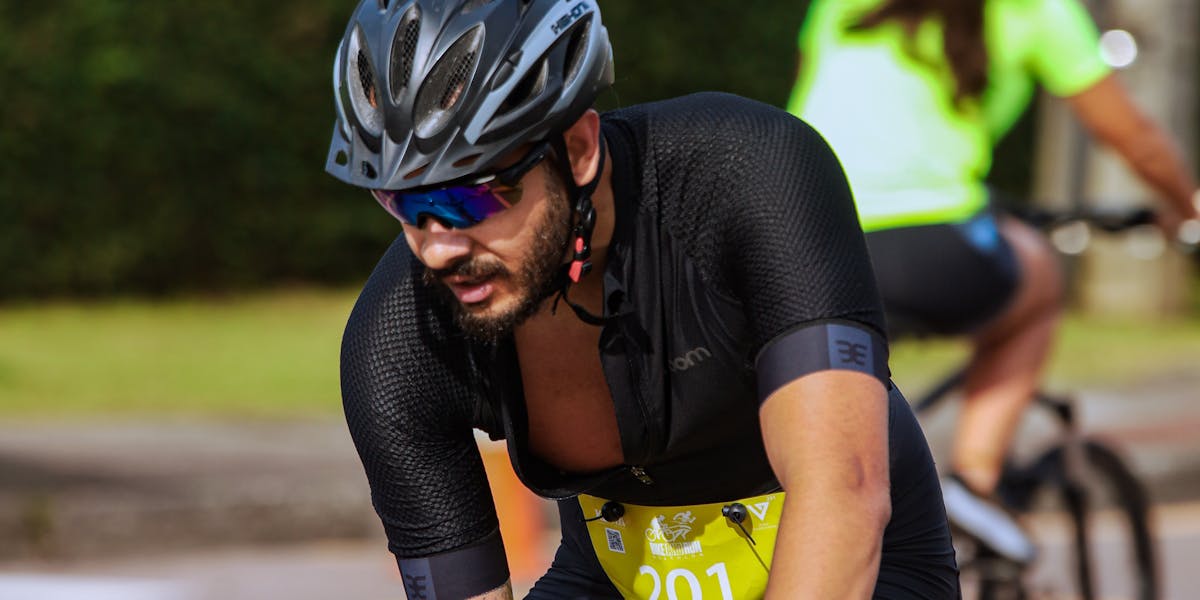 Two cyclists participating in a road race, demonstrating endurance and focus.