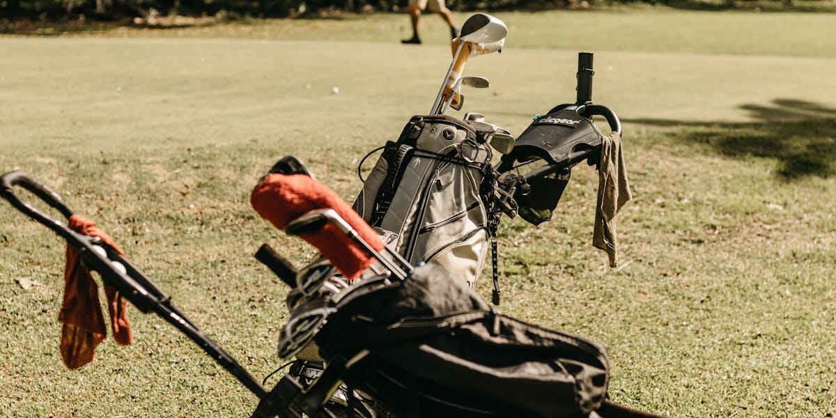 A woman strolls across Solängen golf course in Sweden, pushing a golf cart on a 