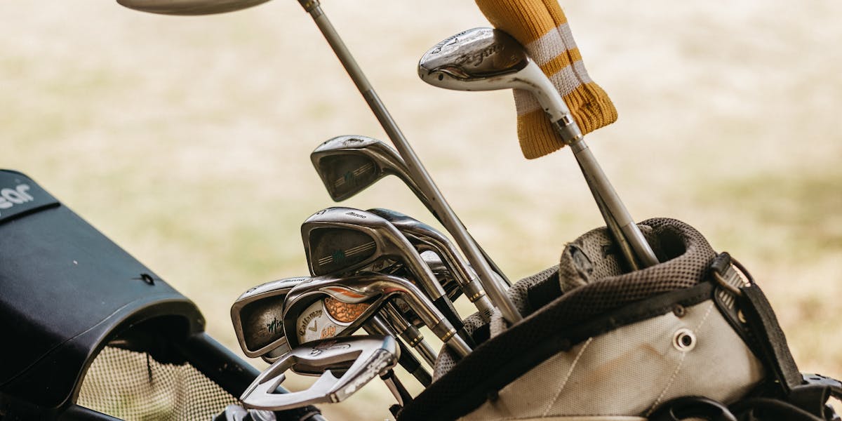 A detailed close-up of golf clubs in a bag, perfect for sports enthusiasts.