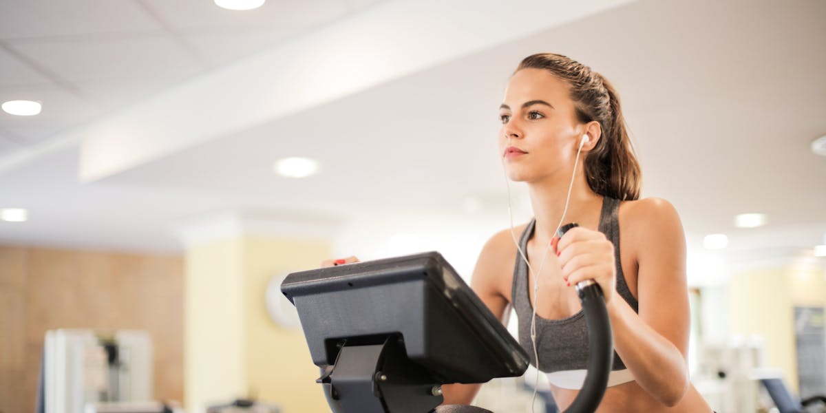 Focused man in gym getting ready for exercise routine. Indoor workout environment.