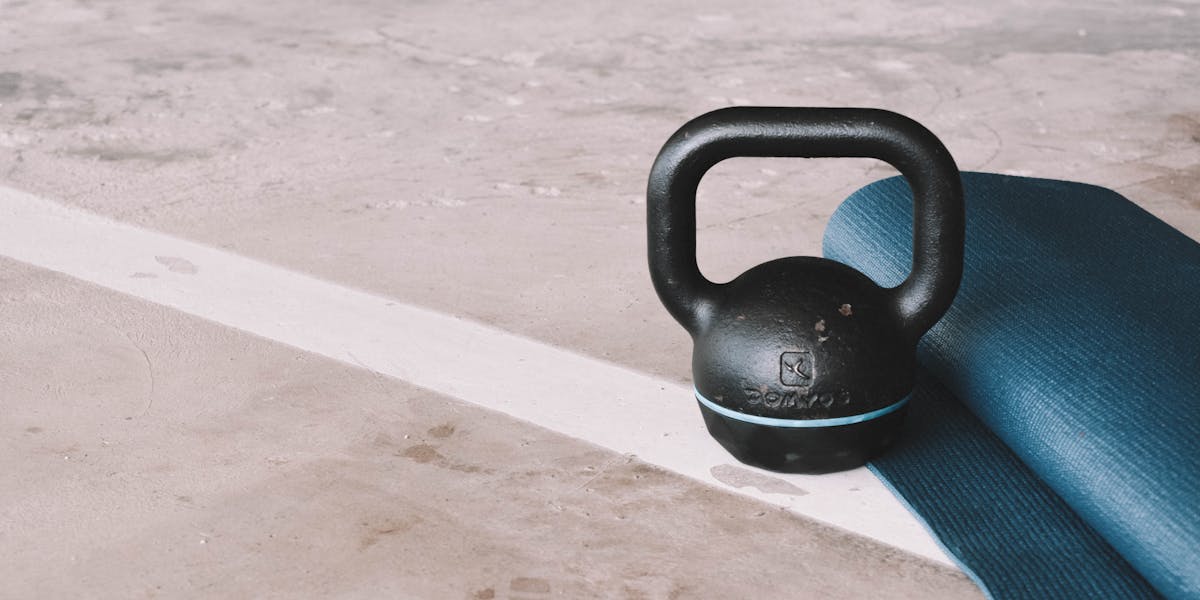 A set of fitness essentials including sneakers, an ab roller, and a water bottle