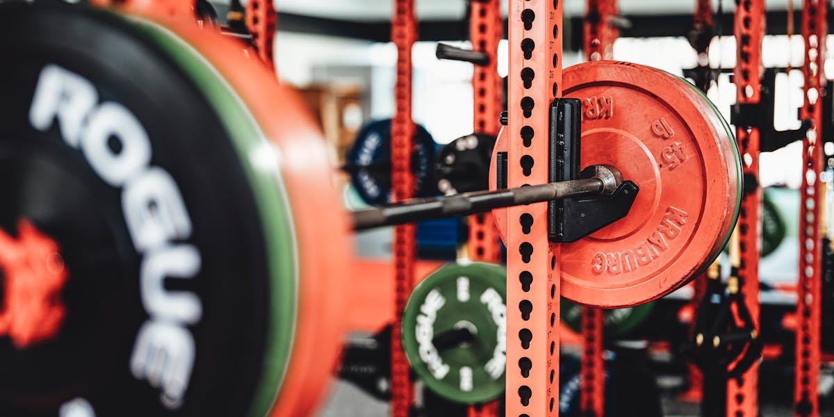 Detailed view of a weightlifting setup in a modern gym featuring colorful weight