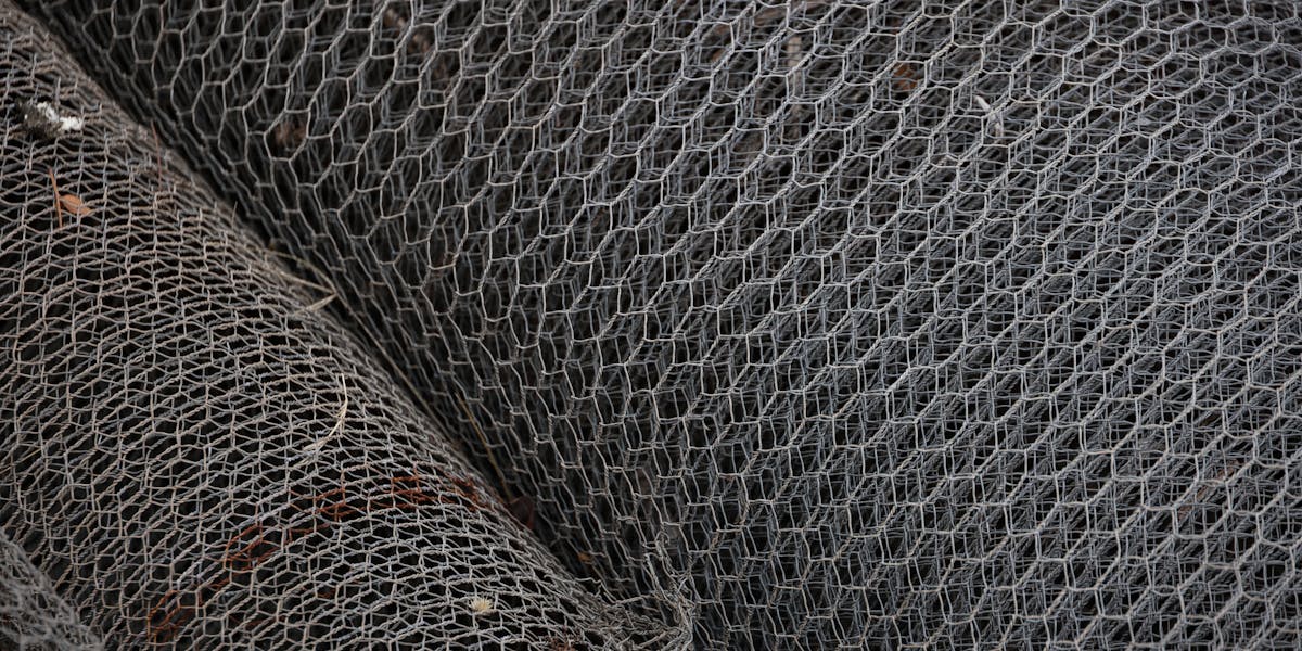 Detailed view of rolled metal wire mesh showcasing intricate patterns, ideal for i...