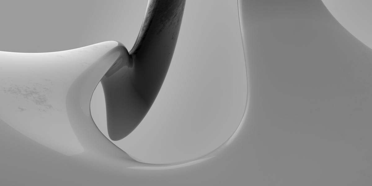 A softball nestled in a lacrosse stick lying on green grass, highlighting sports c...