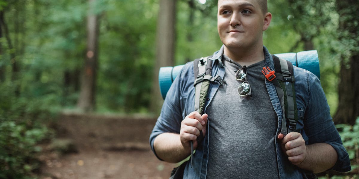 Back view of a hiker with backpack trekking through the scenic trails of Fethiye