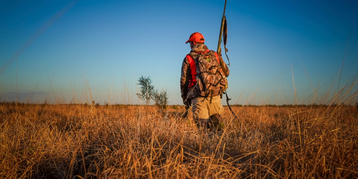 Man in camouflage with crossbow in Florida forest, ready for hunting and adventu
