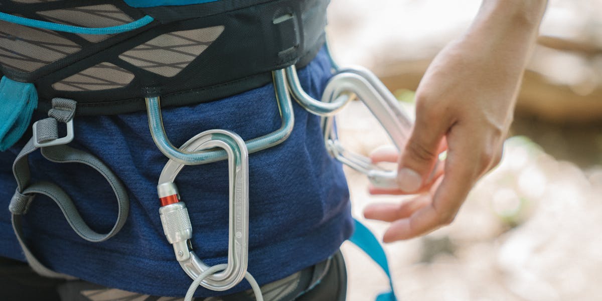 A detailed flat lay of essential survival tools for outdoor adventure and tactical...