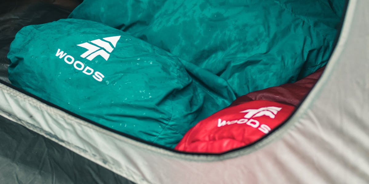Two colorful sleeping bags inside a tent on a camping trip in Canada.
