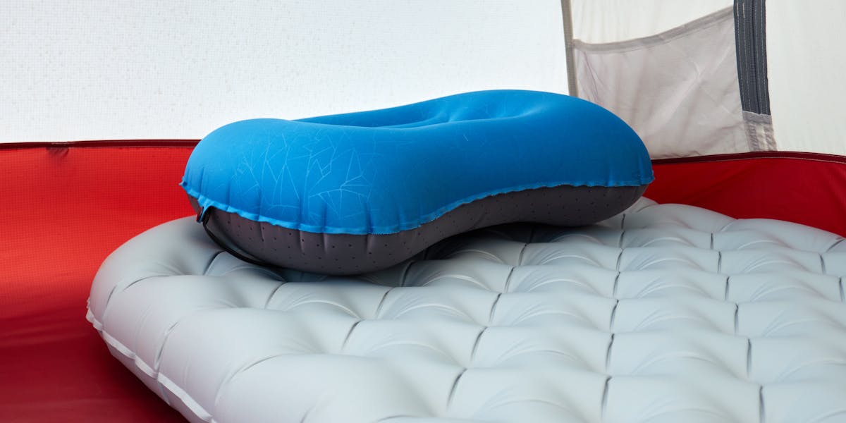 Detailed view of inflatable pillow on sleeping pad inside a tent, perfect for ou