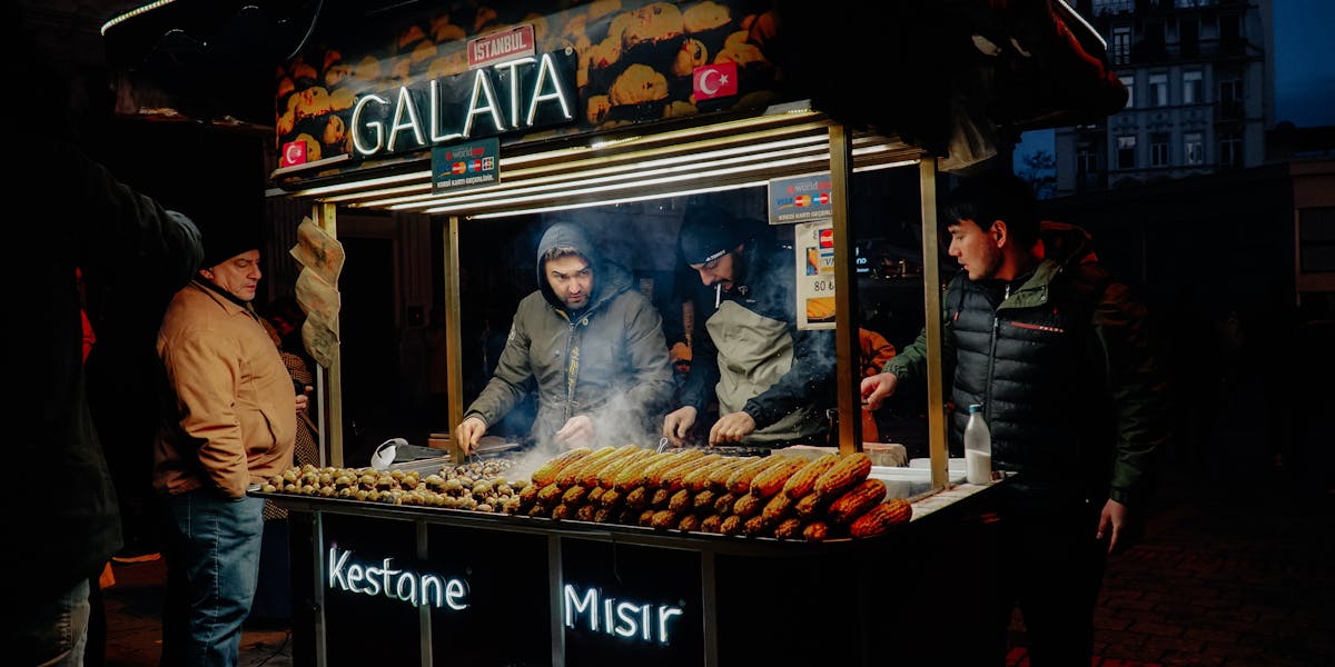 An outdoor tennis court with a cart full of tennis balls, creating a sporty atmo