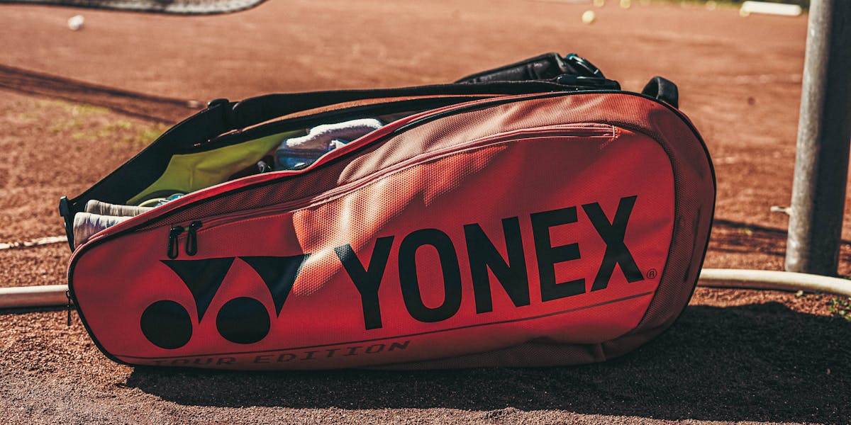 A neatly packed open suitcase with clothing and travel essentials, ready for a trip.