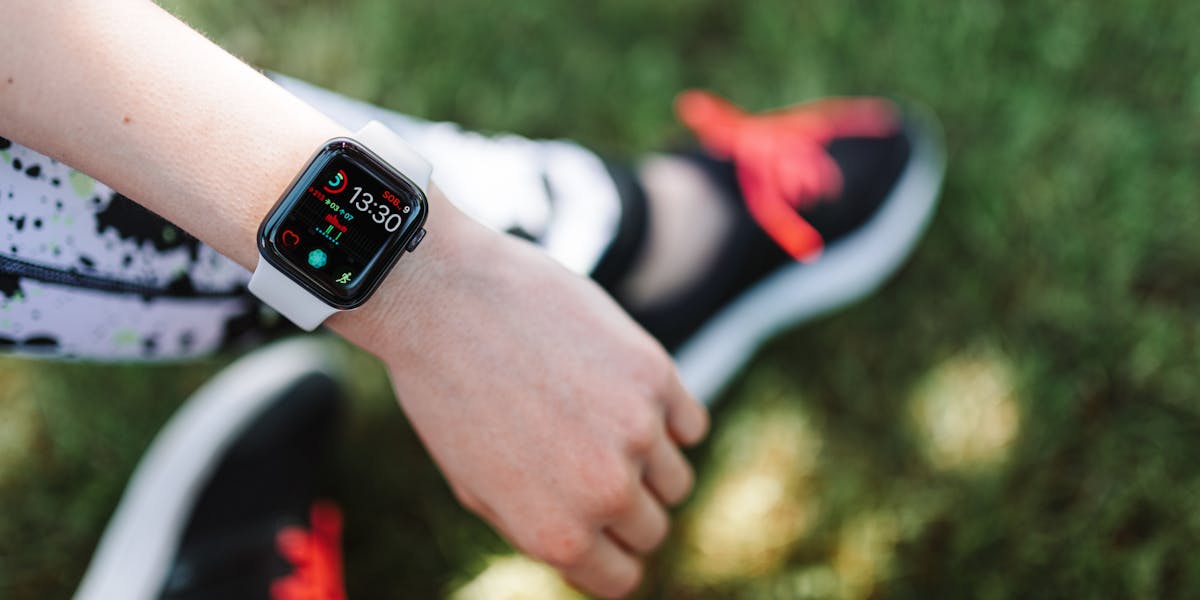 Close-up of a smartwatch on a woman's wrist during outdoor fitness activity.