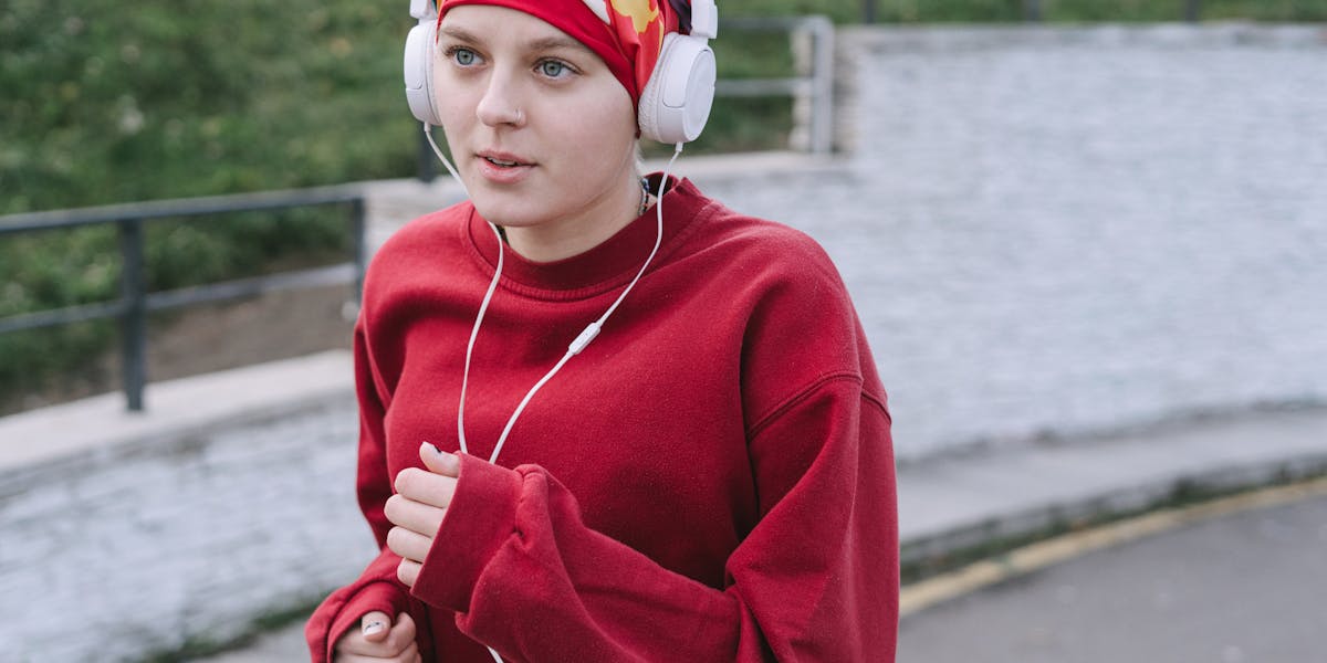 Pair of Audio-Technica headphones displayed on a textured wooden background.