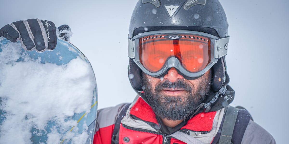 Close-up of gloved hands conducting a scientific experiment with a beaker in a lab...