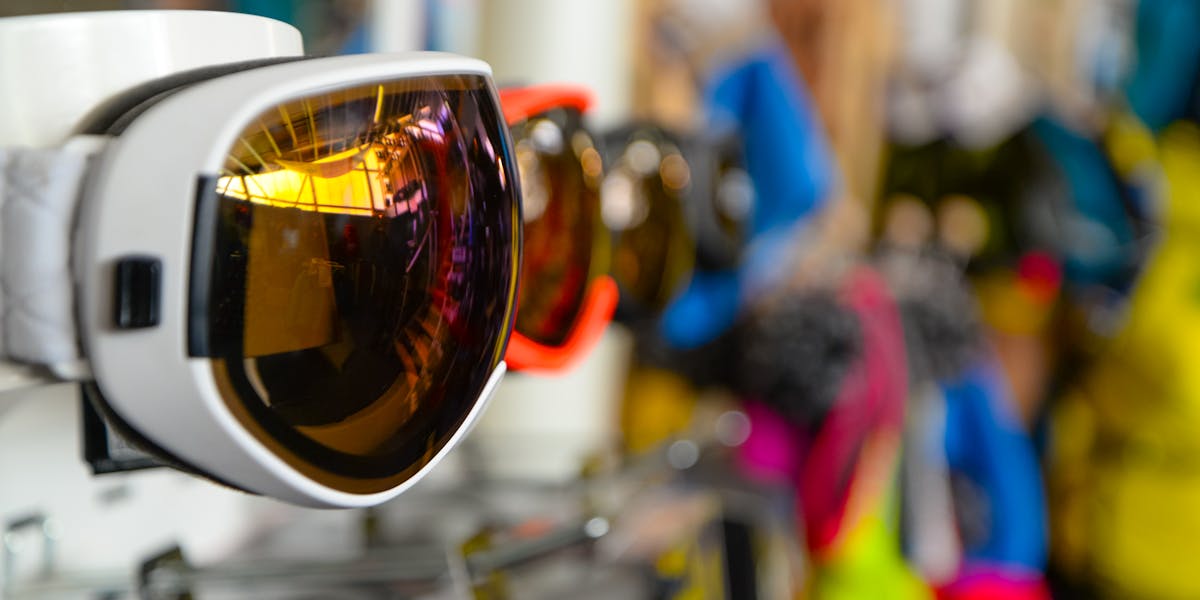 Vibrant ski goggles displayed in a sports store, showcasing reflective lenses and ...