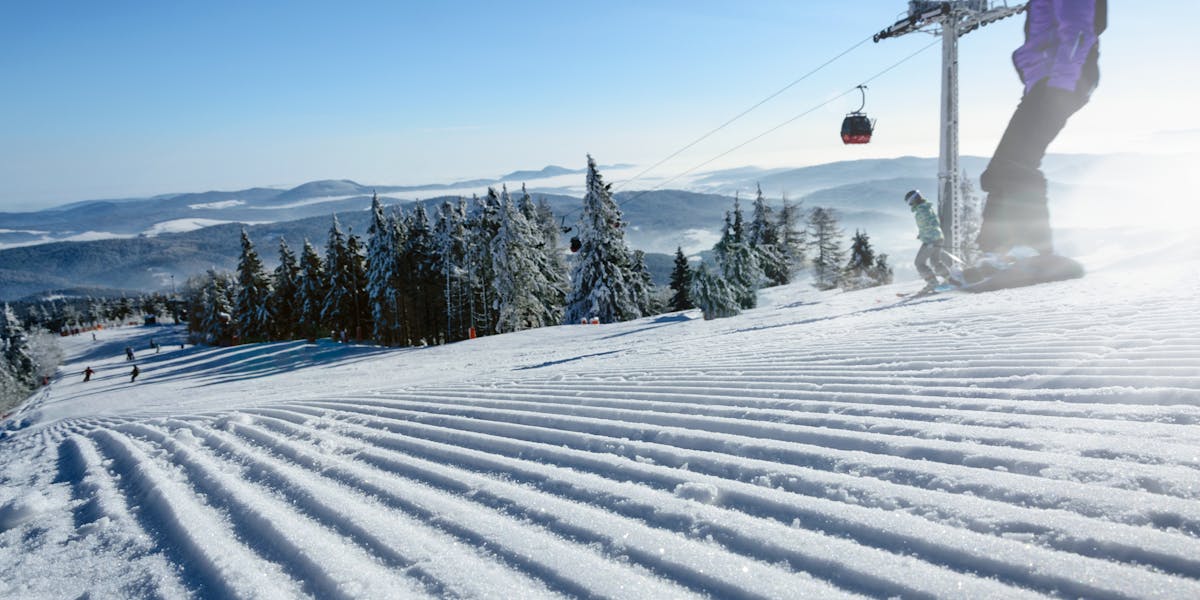 Breathtaking view of skiers on a snowy slope in Hinterstoder, Austria's Alpine r