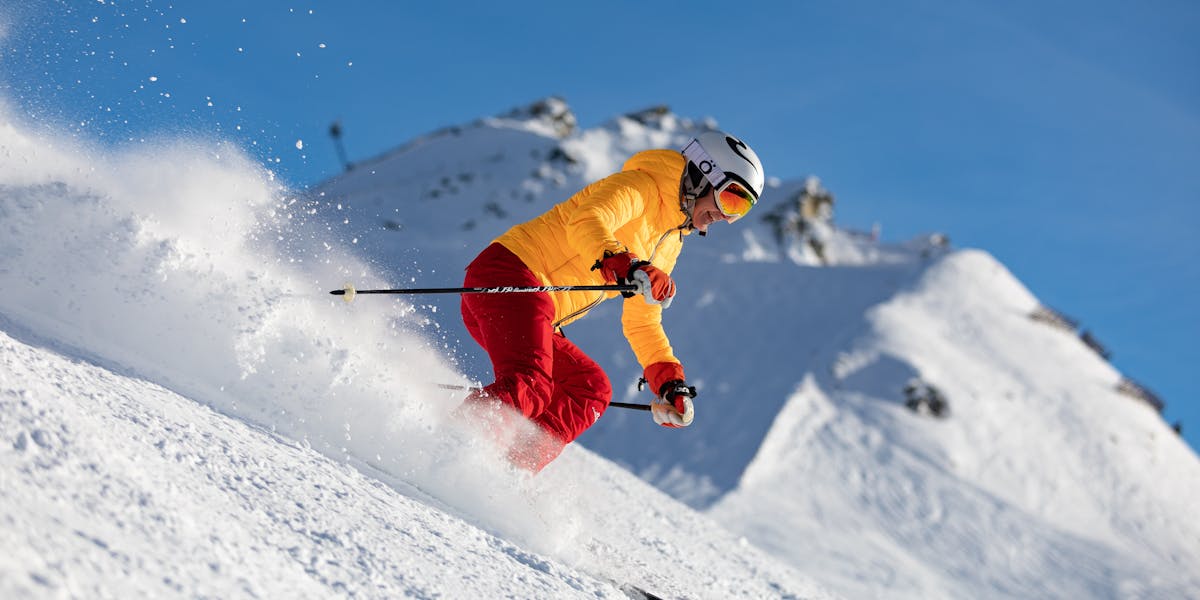 Dynamic capture of a skier racing downhill in snowy mountains, showcasing adrena