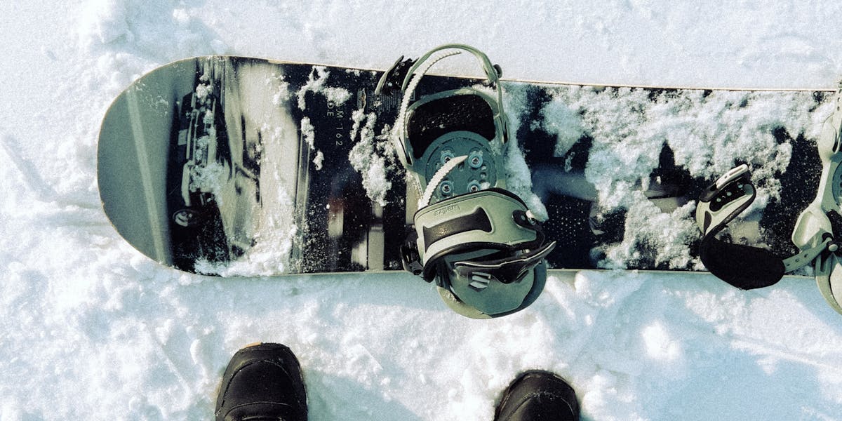 Captivating view of snowboard and boots on a pristine snowy slope, perfect for w
