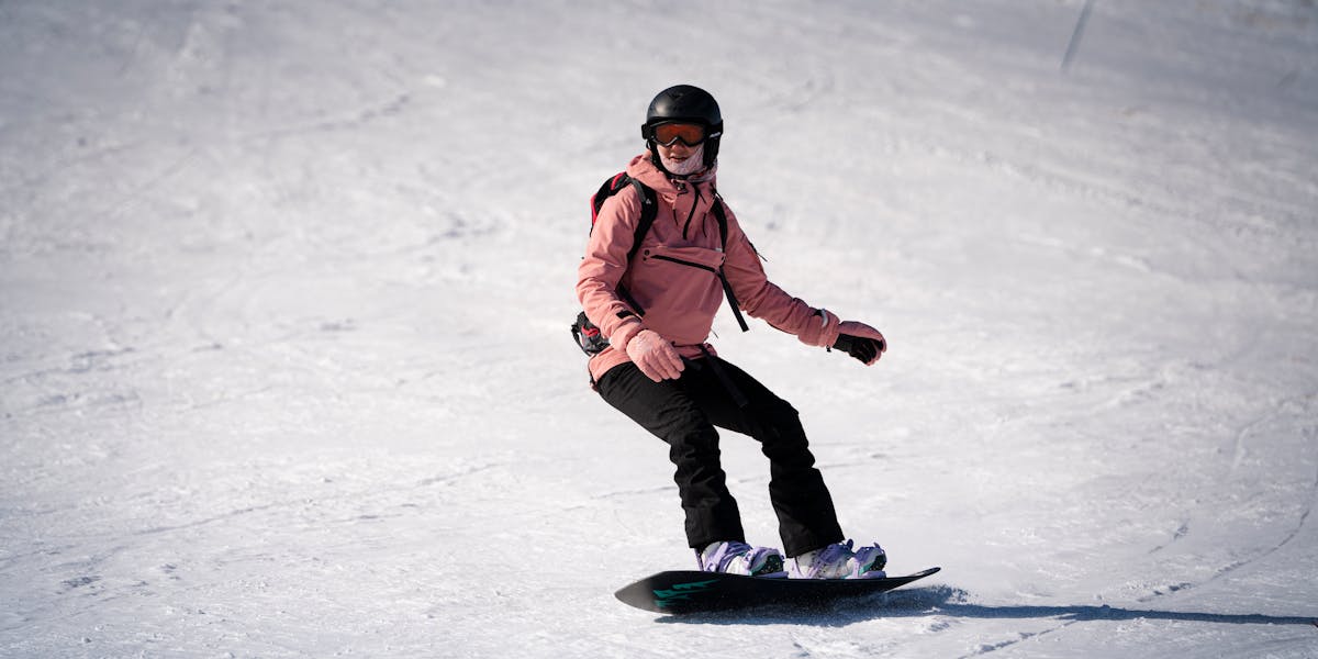 A snowboarder enjoys a thrilling ride down a snowy slope, showcasing winter sports.