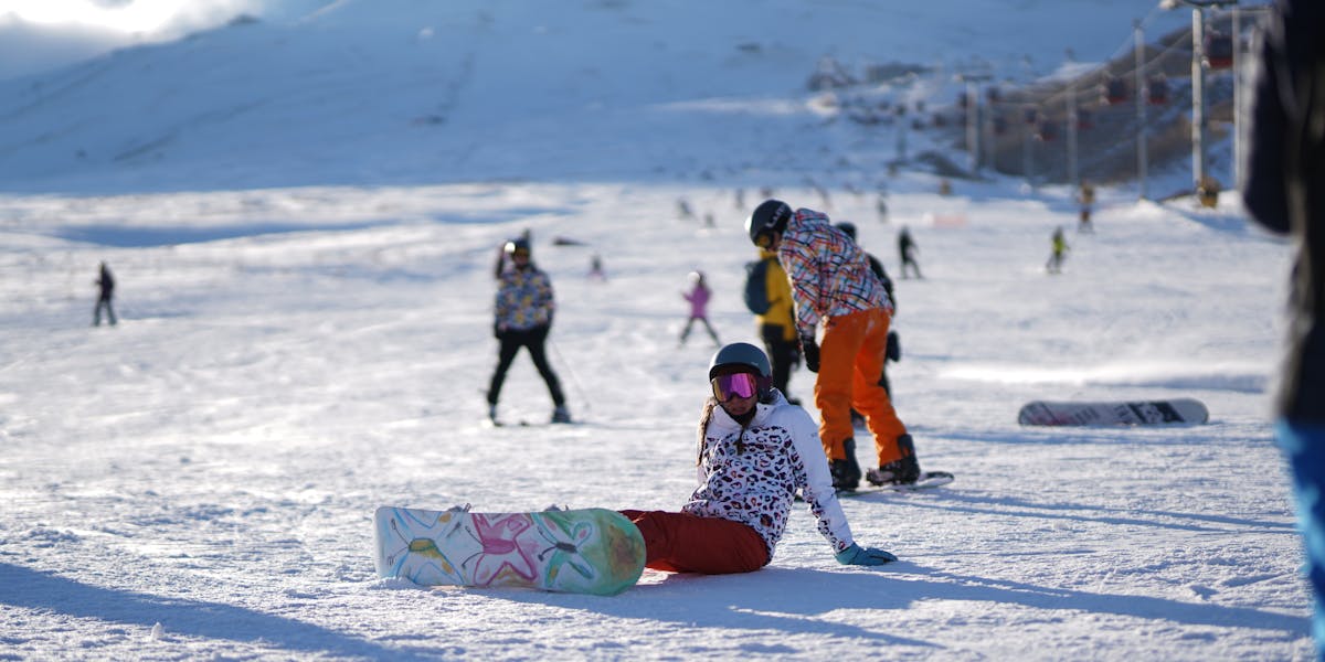 A breathtaking view of snowy mountains with a blue snowshoe in the foreground, c