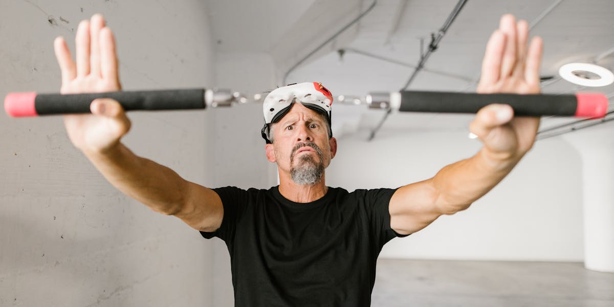 A sleek black action camera lies on a dark surface, showcasing its LCD screen.