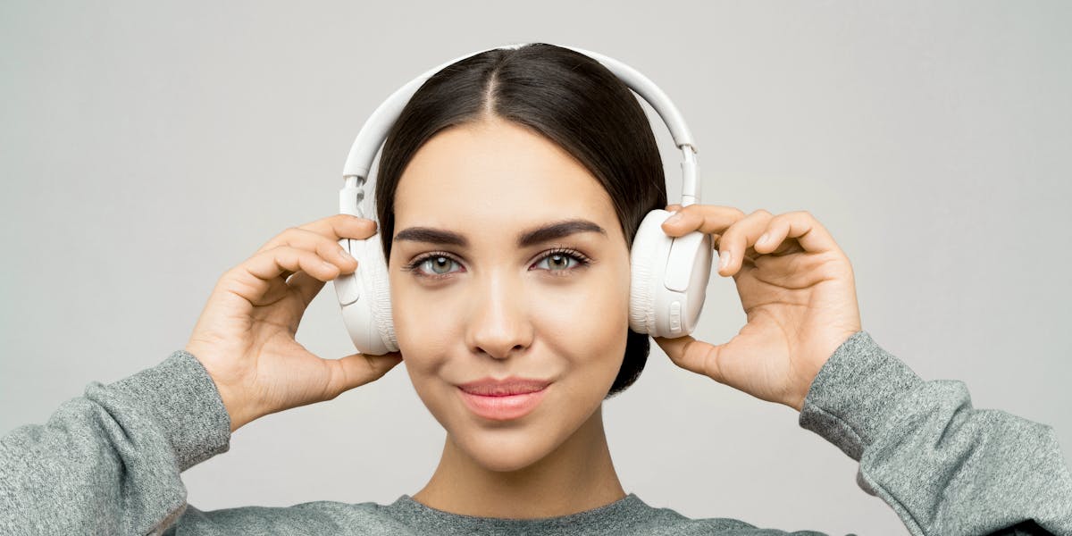 A creepy skull adorned with headphones, casting an eerie vibe against a black back...