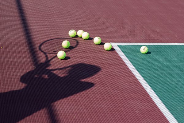 Tennis Court Surfaces Explained: How Clay, Hard, and Grass Change Your Gear Needs