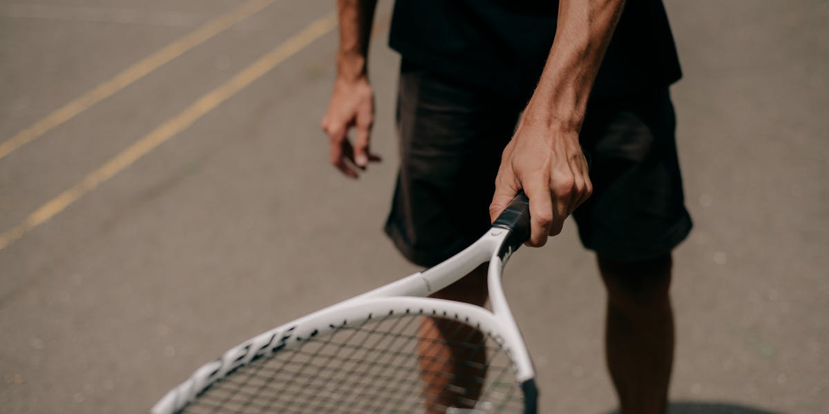 Detailed close-up of a tennis racket, perfect for sports and fitness themes.