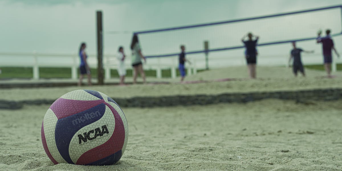 A sand volleyball game in Aurora, Colorado, with a focus on a volleyball.